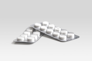 White round pills in blister packs