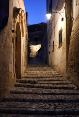 Obraz premium Typical cobbled stairs in a side street alleyway iin the Sassi di Matera a historic district in the city of Matera. Basilicata. Italy