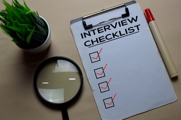 Interview Checlist write on a paperwork isolated on office desk.