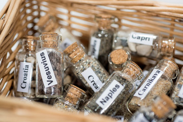 Glass test-tube with sand of different summer vacation countries.