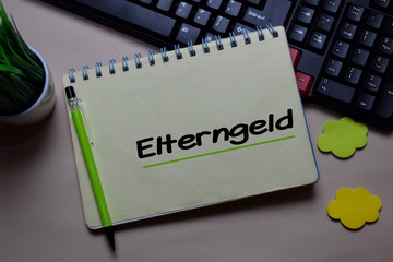 Elterngeld write on a book isolated on office desk. German Language it means Parental Benefits