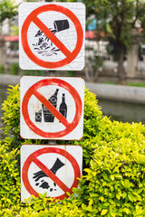 Multi not allowed  sign in the park. Do not throw garbage , Do not drink , Do not feed fish