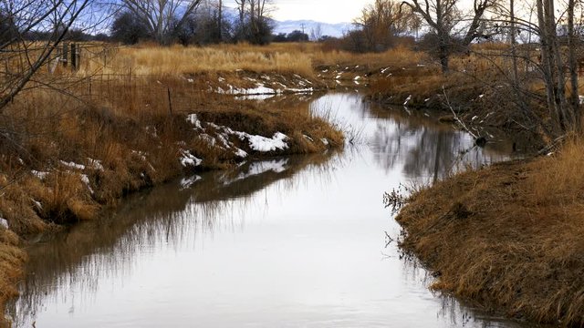 Gentle ripples on slow moving winter stream Sanpitch River-Vibrant
