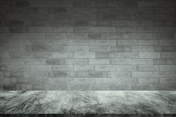 Empty concrete table with old bricks wall background.