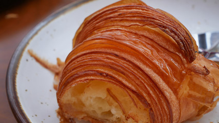 freshly baked croissants on white plate, top view