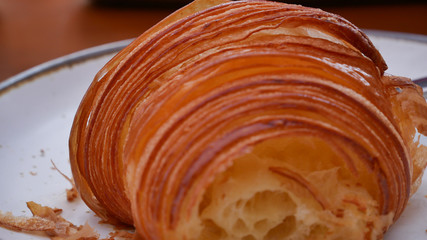 freshly baked croissants on white plate, top view