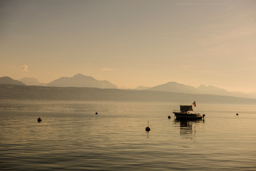 Boat with Swiss Flag on Lake Geneva in Switzerland.