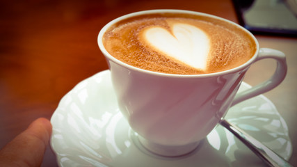 Coffee heart shape in white cup.