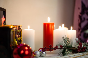 Music box, burning candles, still life on the fireplace new year