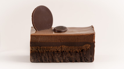 One piece of layered chocolate cake. Isolated, white background