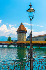 City of Lucerne with Chapel Bridge Tower and Street Lamp in a Sunny Day in Switzerland.