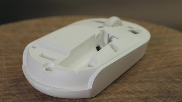 Closeup of the replacement battery into the wireless computer mouse