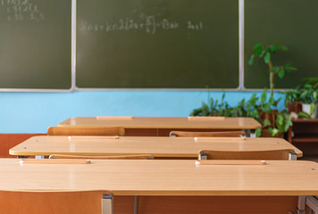 School empty classroom with school desks and blackboard in school. Education concept. Back to school.
