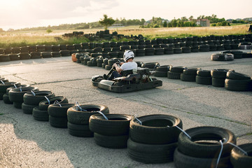 Karting. Man in a white t-shirt. Male with a kart car