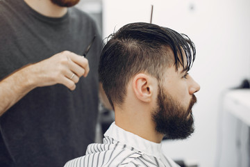 Man with a beard. Hairdresser with a client.