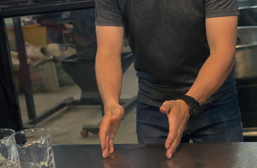  man in a t-shirt shows his hands gestures