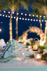 Dining table decorated with beautiful candles at the wedding ceremony.