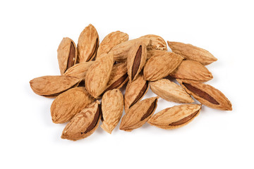 Pile of the unshelled almonds on a white background
