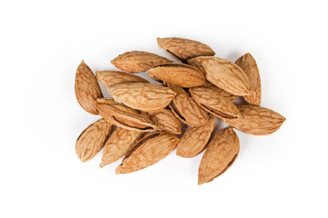Top view of unshelled almonds on a white background