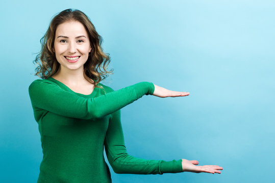 Smiling Woman Holding Virtual Object In Her Hands