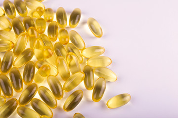 Cod liver oil omega 3 gel capsules on grey background