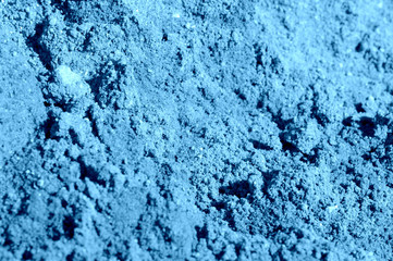 Fototapeta na wymiar Construction sand texture close-up. Natural abstract background blue color toned