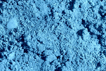 Fototapeta na wymiar Construction sand texture close-up. Natural abstract background blue color toned