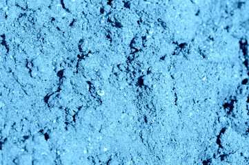 Fototapeta na wymiar Construction sand texture close-up. Natural abstract background blue color toned