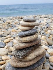 Fototapeta na wymiar Stones standing in balance against the sea