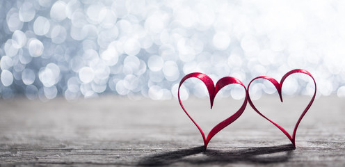 Red ribbon hearts on glitters