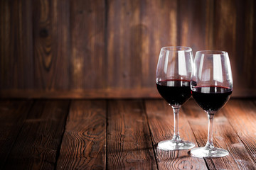 Red wine glasses on wood