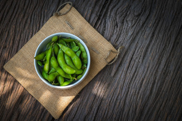 Green Japanese Soybean in white bowl on table wood