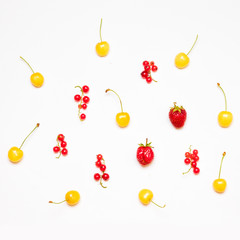 Summer pattern of red currants, ripe strawberries, yellow cherries isolated on light background