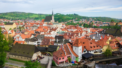 Fototapeta na wymiar Aerial panoramic view of the typical colorful houses of Cesky Krumlov with St. Vitus Church at the background (Czech Republic)