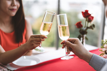 Smile asian lover couple man and woman hand hold a champagne drink and cheer.