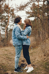 Fototapeta premium gentle and stylish couple are having a walk in the autumn park