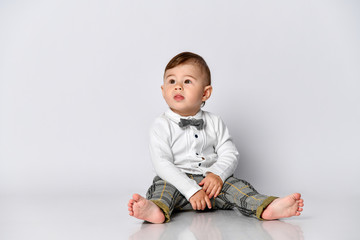 Happy baby. Little boy in a white shirt and bow tie. Children portrait. Stylish man in fashionable a bow-tie.