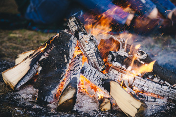 Cooking in field conditions, boiling pot at the campfire on picnic. Filtered image:cross processed vintage effect.