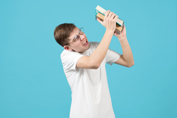 nerd squints and screams, hiding behind books from an invisible threat