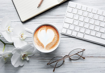 A cup of coffee with heart pattern on a table