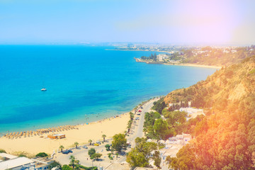 Fototapeta na wymiar Sea Bay, beach, promenade and coastal road in Sidi Bou said, top view. Mediterranean, Tunisia. June, 2019