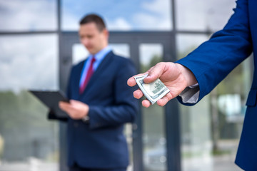 Male hands with dollar banknotes outdoors close up