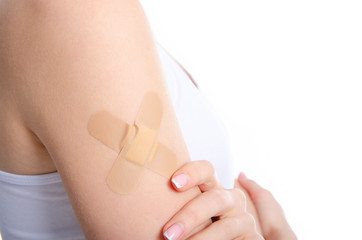 Woman shoulder hand with medical patch plaster on white background isolation