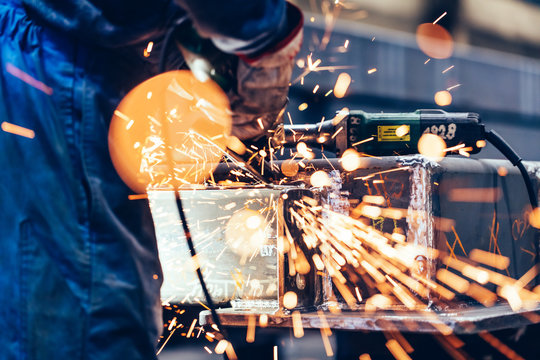 Worker Grinding In A Workshop. Heavy Industry Factory