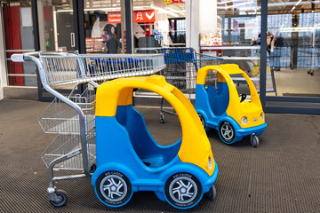 Entrance to a supermarket in Finland. Carts for products in the form of children's cars.