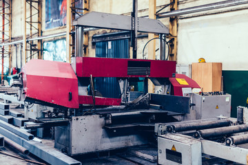 Saw machine for cutting steel profiles in a factory,