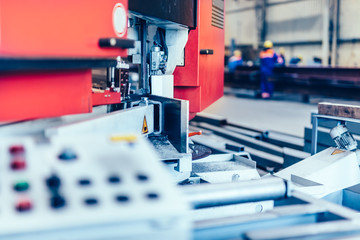 Saw machine for cutting steel profiles in a factory,