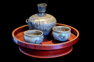 Japanese earthenware glazed sake (rice wine) set on a Chinese lacquered bamboo tray