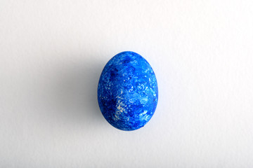 top view one Easter egg in the color of year-classic blue on white background
