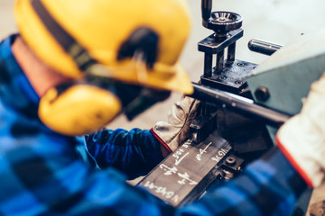 Manual steel plate bevelling process in a factory, workshop